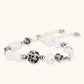 Adjustable beaded bracelet with spotted dalmatian stones, clear quartz crystals, and silver star charm on white background.